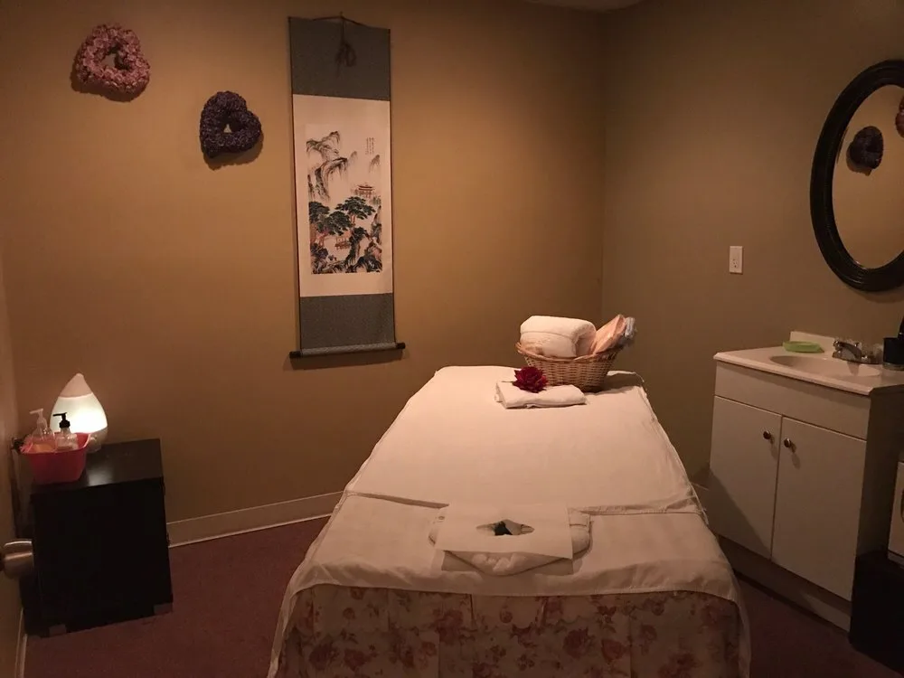 Tranquil massage room with scroll art and warm lighting